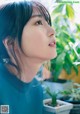 A woman with long black hair looking up at the sky.